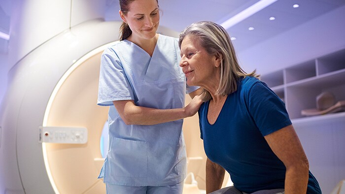 Nurse helping patient stand up