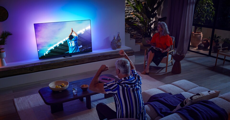 Rodina sleduje zápas na OLED televizi